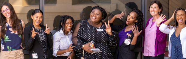 More Stanford HBMC community members strike a funny pose at a 2022 program breakfast
